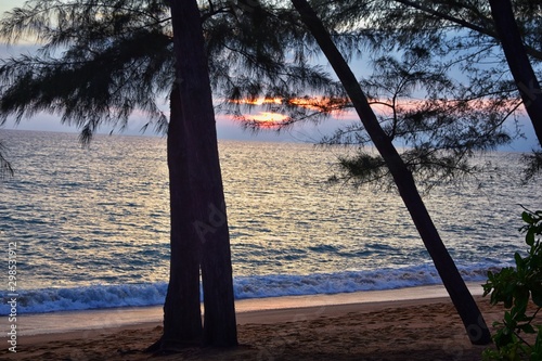 Phuket beach sunset  colorful cloudy twilight sky reflecting on the sand gazing at the Indian Ocean  Thailand  Asia.