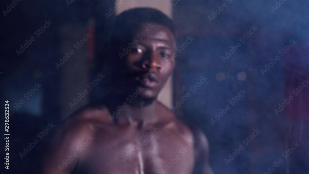 Close Up Portrait Of Man Boxer At Boxing gym in the warehouse Close Up Portrait Of Man Boxer At Boxing gym in the warehouse