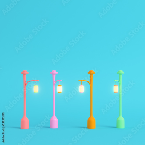 Four colorful street lights on bright blue background in pastel colors. Minimalism concept