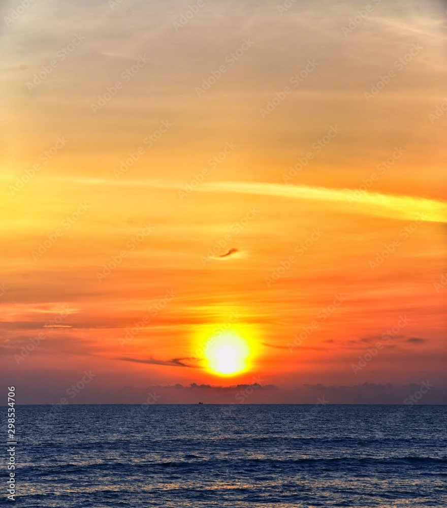 Phuket beach sunset, colorful cloudy twilight sky reflecting on the sand gazing at the Indian Ocean, Thailand, Asia. Phuket beach sunset, colorful cloudy twilight sky reflecting on the sand gazing at the Indian Ocean, Thailand, Asia.