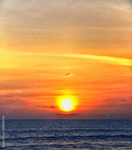 Fototapeta Naklejka Na Ścianę i Meble -  Phuket beach sunset, colorful cloudy twilight sky reflecting on the sand gazing at the Indian Ocean, Thailand, Asia.