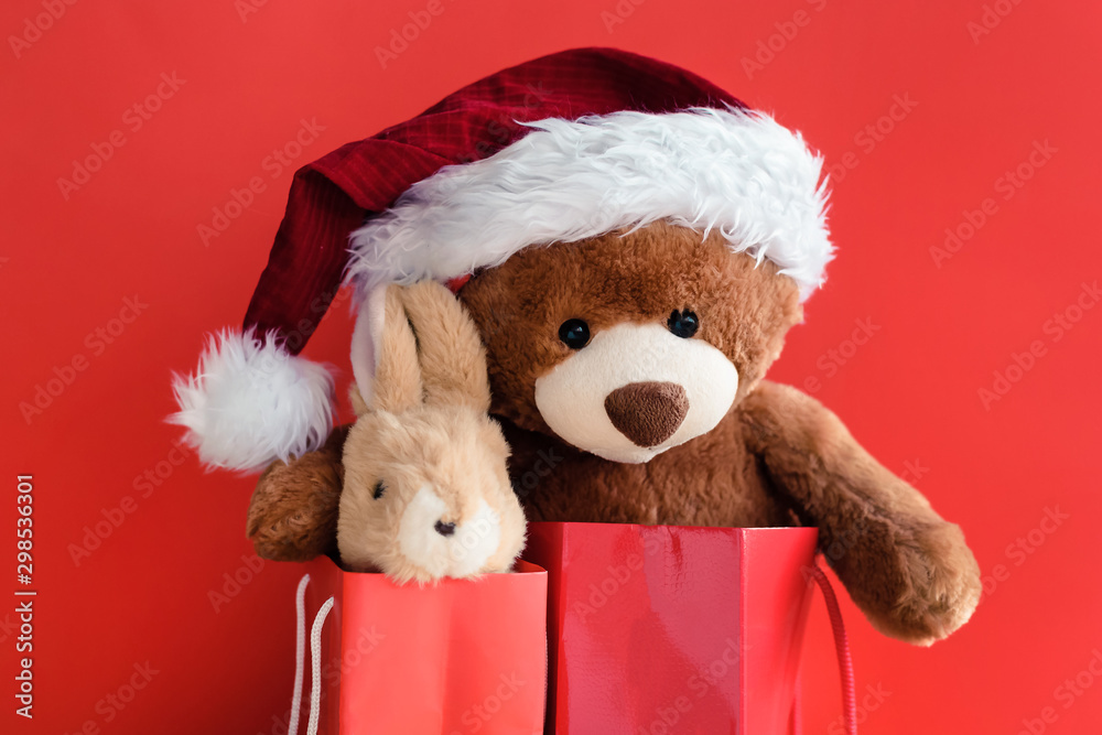 Christmas card with Teddy and banny in red gift bags. With holiday decoration and presents Christmas card with Teddy and banny in red gift bags. With holiday decoration and presents