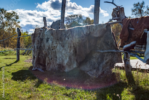 national clothes made of reindeer skins and reindeer skins on the background photo