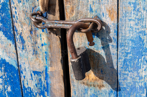 the old-fashioned latch on the door, the old castle, retro style, blue fence © daniiD