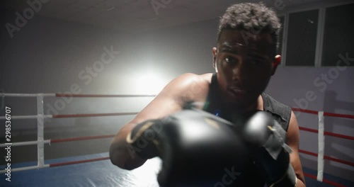 African american sportsman sparring on a boxing ring, punching his opponent at camera - sports, active way of life concept 4k footage photo