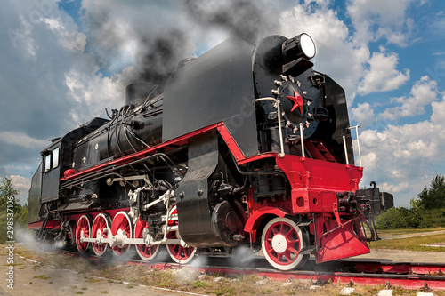 vintage steam train hurtling at speed along the rails close-up, retro vehicle, steam engine