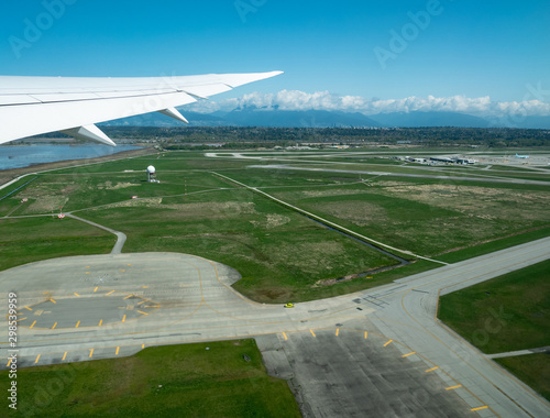 Beautiful Vancouver bay , airport, and mountain seen from airplane photo