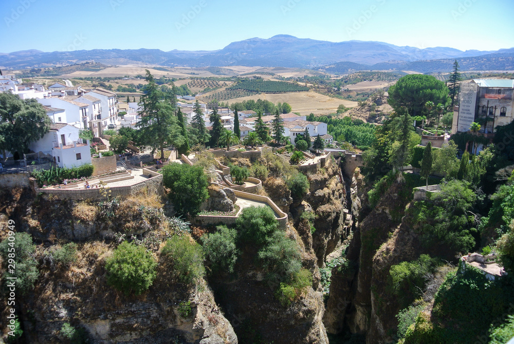 Beautiful city of ronda, Spain. Old buildings in the edge of the canyon and puento nuevo bridge.