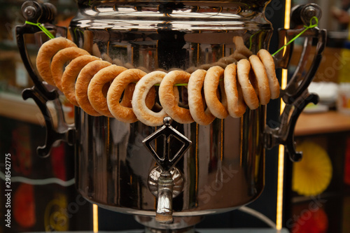 Russian large iron kettle Samovar with a round of dry bread photo