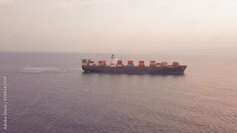 Large container ship in calm ocean water. Large container ship in calm ocean water.