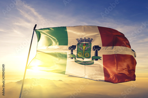 Osasco of Brazil flag waving on the top sunrise mist fog