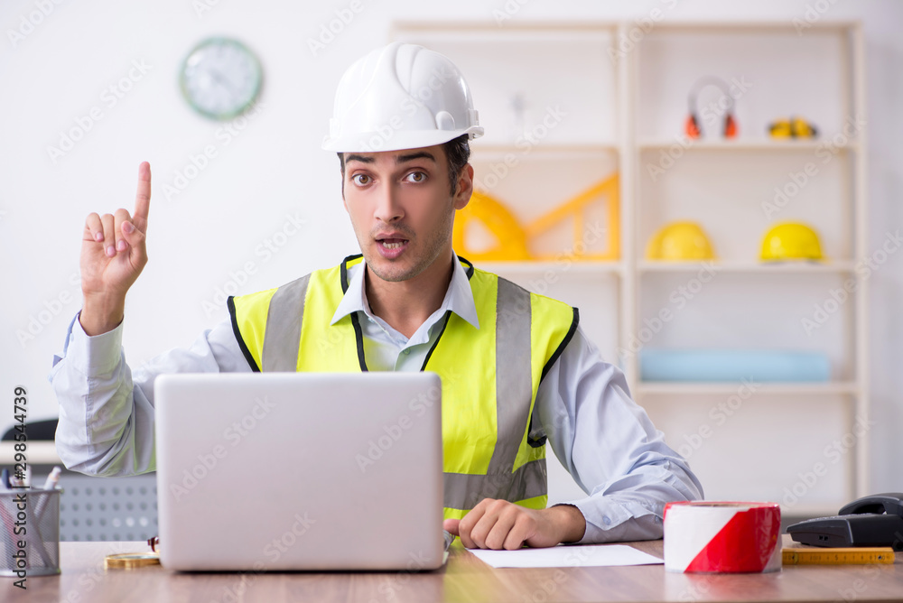 Young male architect working in the office Young male architect working in the office