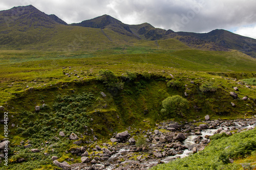 Nearby Carrantuohill Mountain  way to the pick  river and road  Co. Kerry  Ireland summer