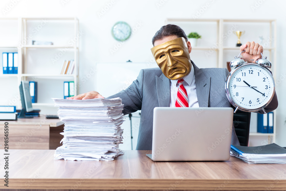Businessman wearing mask in hypocrisy concept Businessman wearing mask in hypocrisy concept