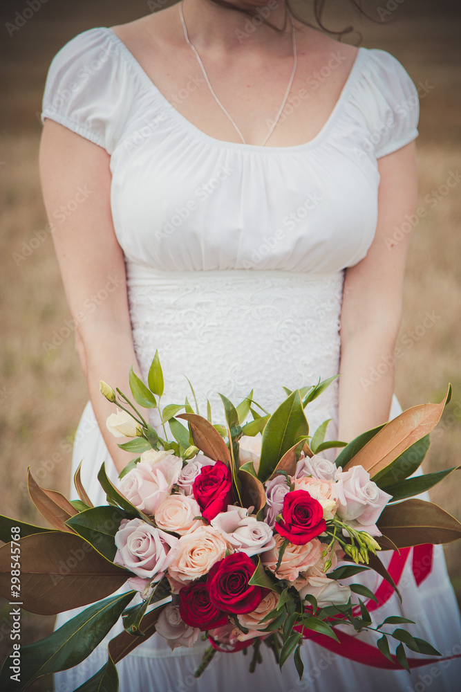 Bride in a dress and with a bouquet in her hands