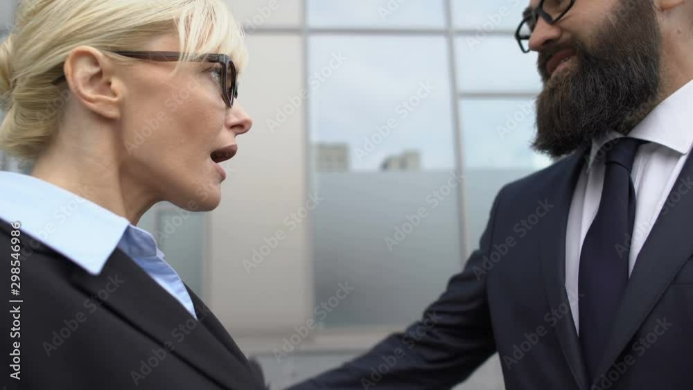 Confused woman stops male colleagues flirt attempt at work, workplace harassment Confused woman stops male colleagues flirt attempt at work, workplace harassment