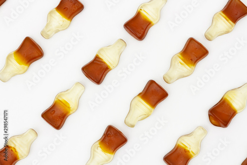 Chewing marmalade sweet Haribo Happy Cola bottles shapes pattern on isolated white background, flavored soda sugar chewing gum Coca Cola shaped bottles, Cola tasty liquorice gummy candy, penny sweets