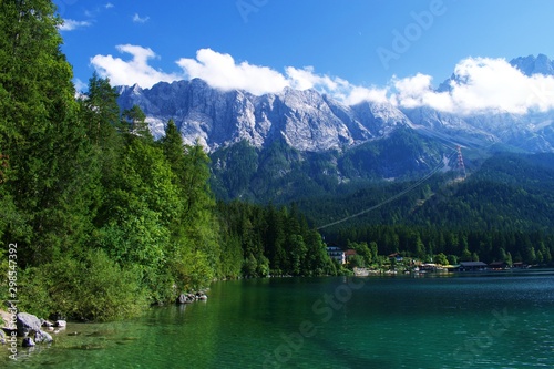 View of Eibsee lake in Bavaria, Germany with Mountain in the background and a hotel at the lake shore