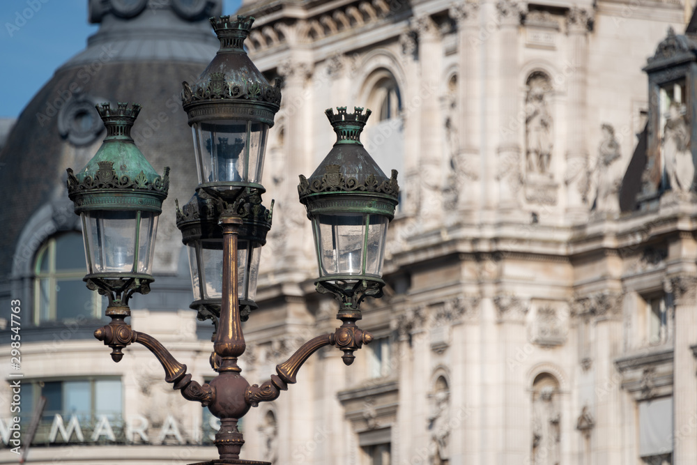 Ornate street lights with old european building in background