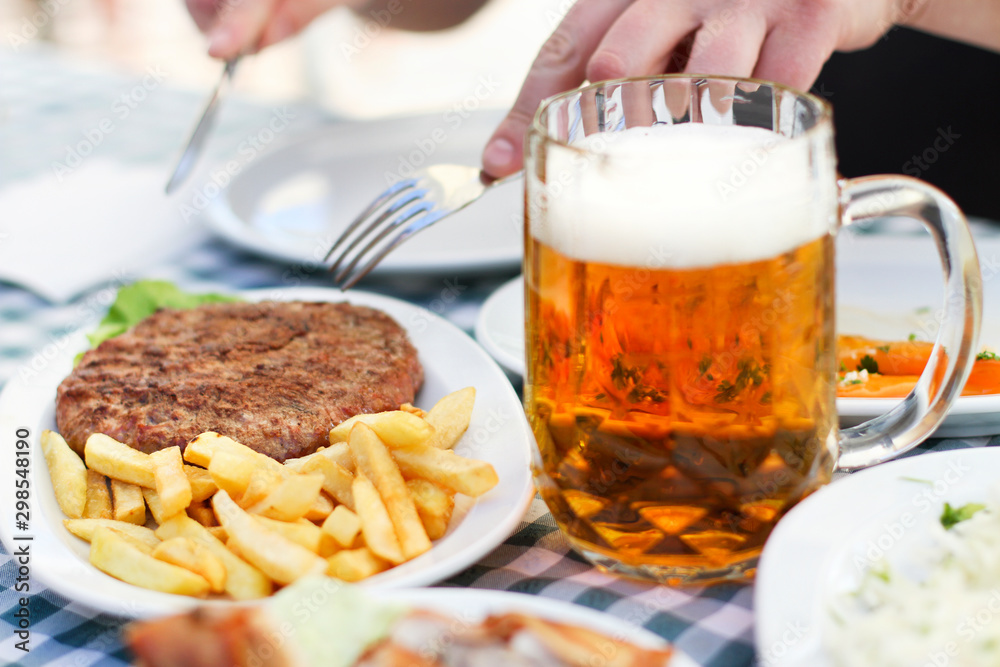 Meal - Burger Fries and Beer Served on the Table Meal - Burger Fries and Beer Served on the Table
