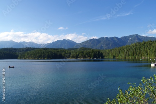 View of Lake Eibsee in Bavaria, Germany, with people in cannoe