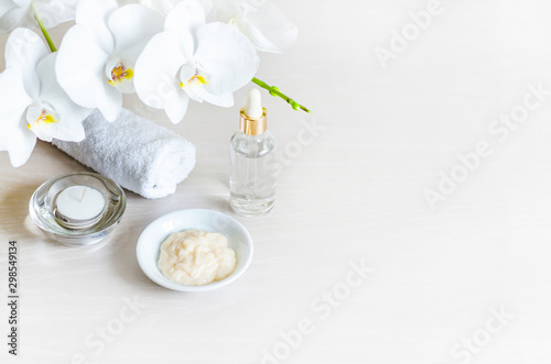 natural cosmetic products  ingredients on light background  mask  serum  cream. clean skin  face care. extension of youth. orchid extract. spa treatments. beauty concept. copy space  soft focus  text