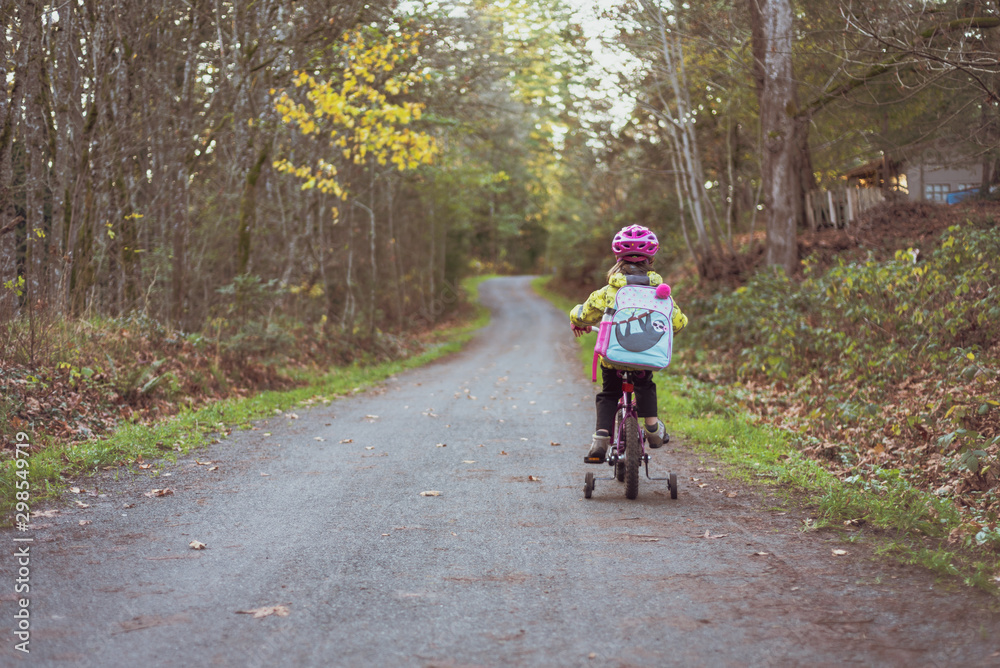 girl riding a bike in fall