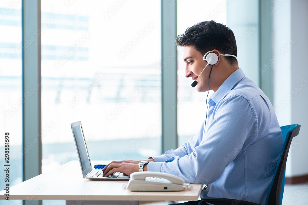 Male call-center operator in business concept Male call-center operator in business concept