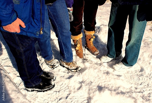 The footwear in the snow of a group of winter walkers