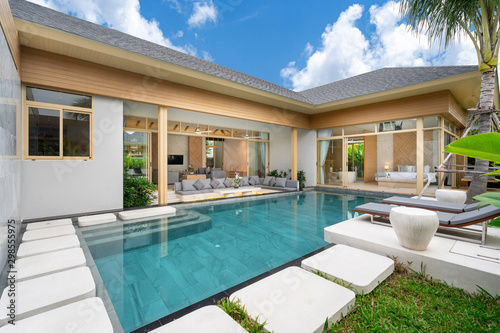 home or house Exterior design showing tropical pool villa with greenery garden © Stock PK