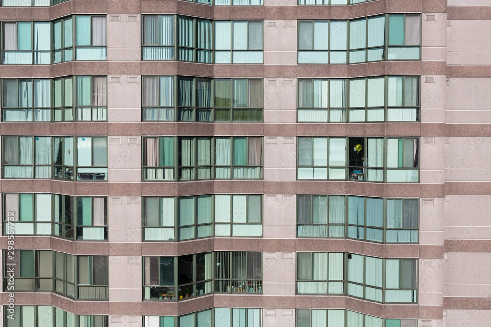 A large apartment style building with a lot of windows A large apartment style building with a lot of windows