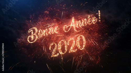 2020 Happy New Year greeting text in French with particles and sparks on black night sky with colored fireworks on background, beautiful typography magic design.