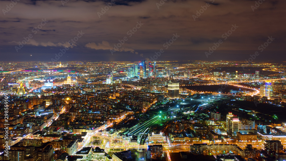 Amazingly beautiful motion of Moscow city on the night, view from above. Picturesque aerial panorama of Moscow center with bright glittering lights from buildings, streets and traffic.