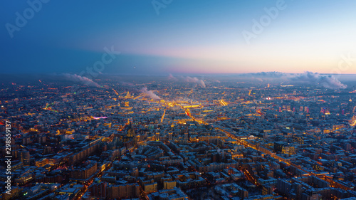 Beautiful aerial view to Moscow city on the sunset. Picturesque motion of the evening metropolis with street and building lights gradually turning on and colorful sky on the background.