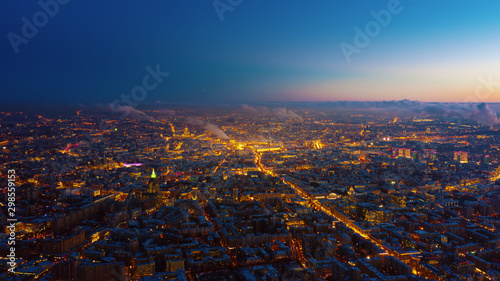 Beautiful aerial view to Moscow city on the sunset. Picturesque motion of the evening metropolis with street and building lights gradually turning on and colorful sky on the background.