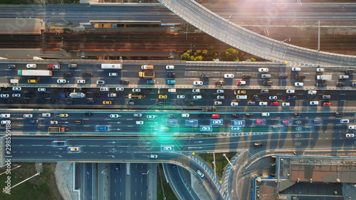 Beautiful top view to autonomous cars self-driving on multi-level highway in Moscow. Picturesque aerial panorama of the road traffic in a big city on the evening.