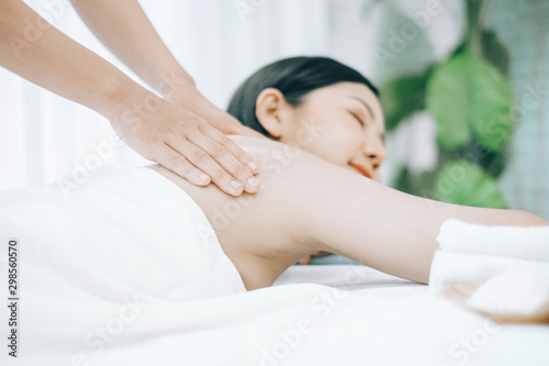 Beautiful young woman lying down on beds massage and spa at asian spa massage and beauty salon center, spa concept, massage concept