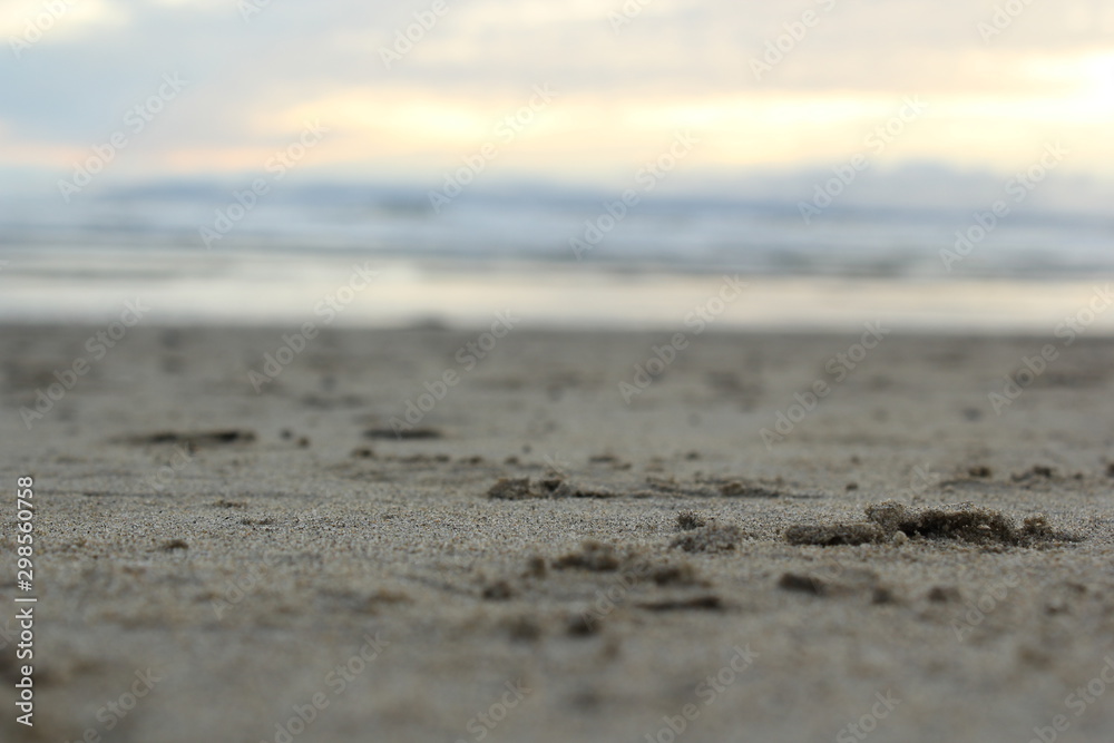 Sand on a beach with ocean in background Sand on a beach with ocean in background