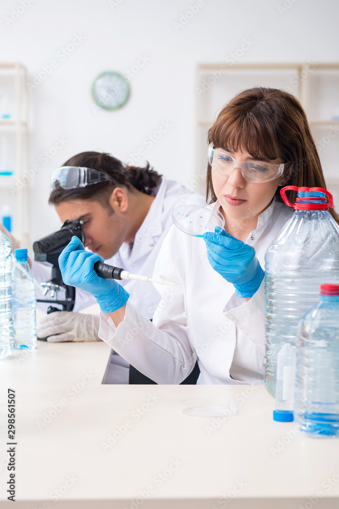 Two chemists working in the lab Two chemists working in the lab
