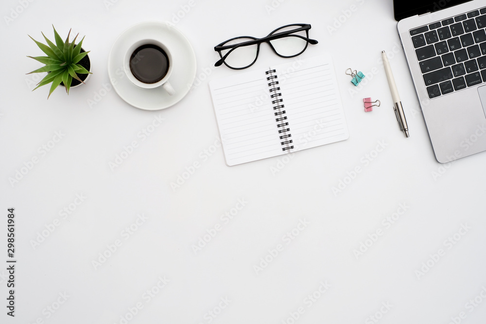 Work space office business and finance concept on white table desk background with laptop computer and coffee cup, green plant and glasses, Top view with copy space, flat lay Work space office business and finance concept on white table desk background with laptop computer and coffee cup, green plant and glasses, Top view with copy space, flat lay