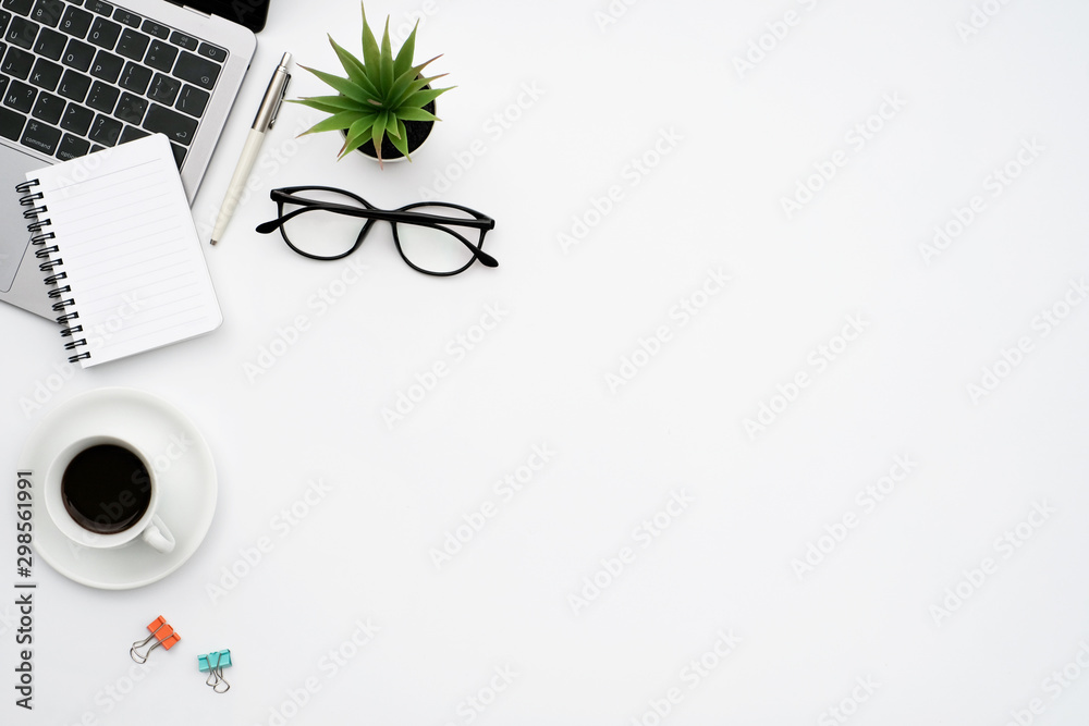 Work space office business and finance concept on white table desk background with laptop computer and coffee cup, green plant and glasses, Top view with copy space, flat lay