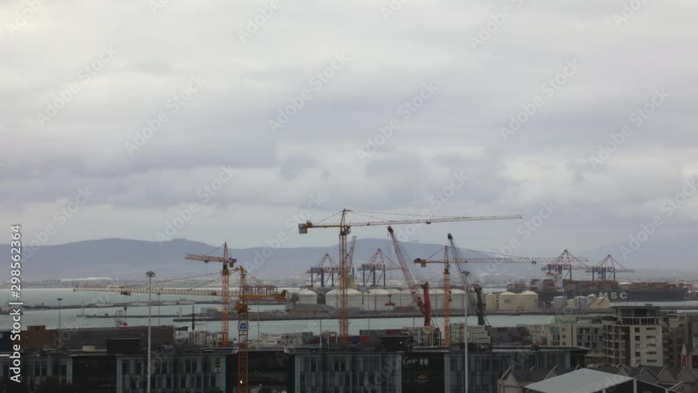 Time Lapse on a cloudy overcast day overlooking the harbour while cranes are working Time Lapse on a cloudy overcast day overlooking the harbour while cranes are working