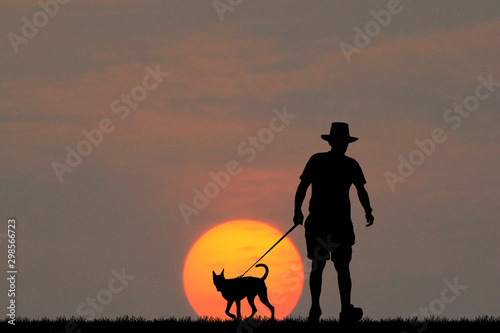Silhouett man and dog on sunrise
