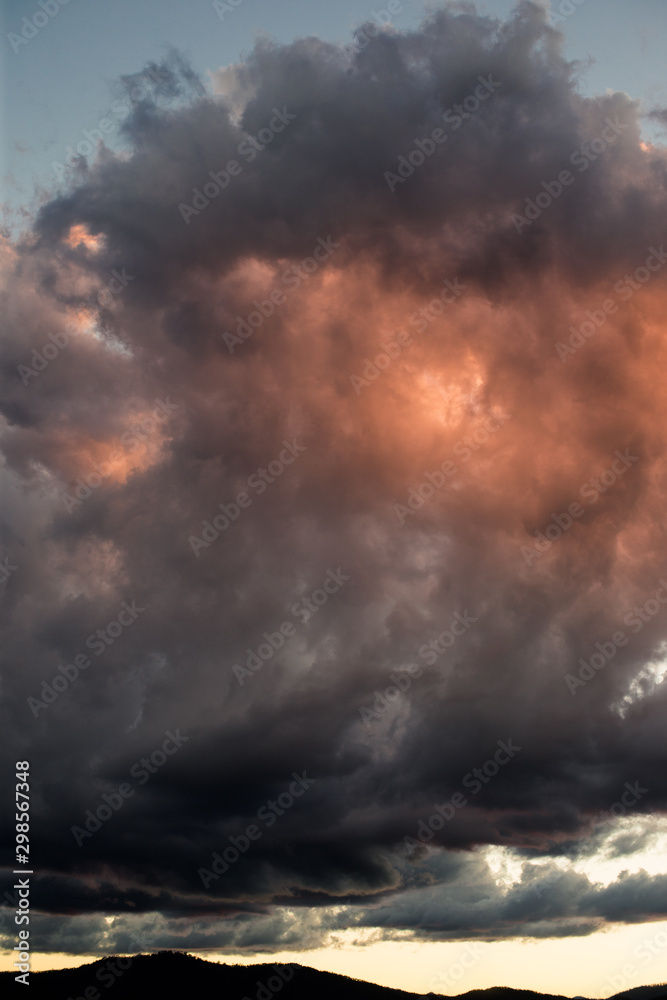 a beautiful mound of clouds covering the sun on golden hour