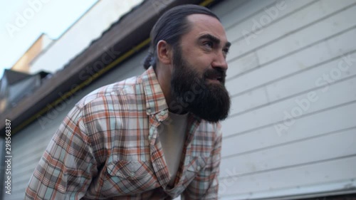 Bearded male suffering acute abdominal pain outdoors, constipation symptom