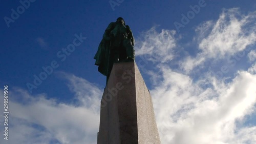 The statue of Leifur Eiríksson standing tall outside of Hallgrimskirkja during the day, in Iceland. photo