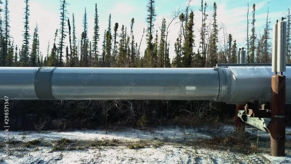 Side on close up aerial shot of a large industrial oil pipeline in the Copper River Valley in the Alaskan Interior Side on close up aerial shot of a large industrial oil pipeline in the Copper River Valley in the Alaskan Interior