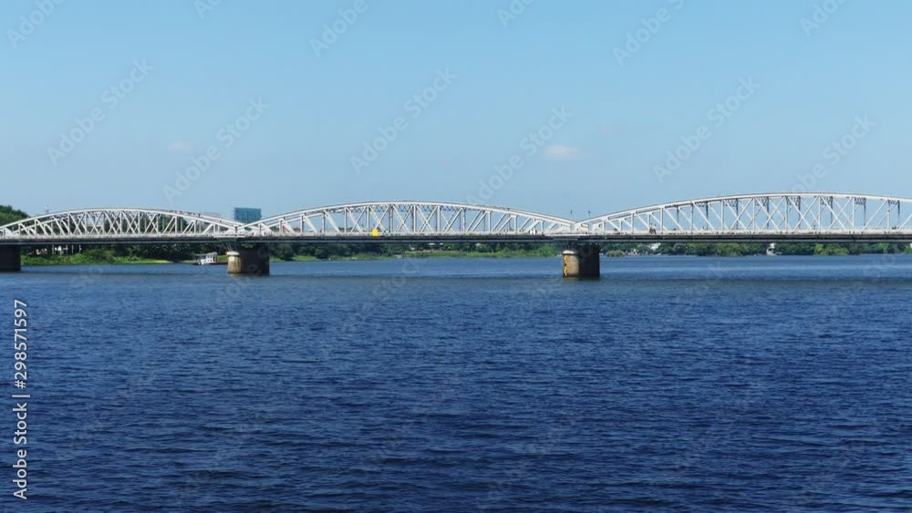 Wide shot of a bridge with a lot of traffic on it crossing a huge river. Wide shot of a bridge with a lot of traffic on it crossing a huge river.