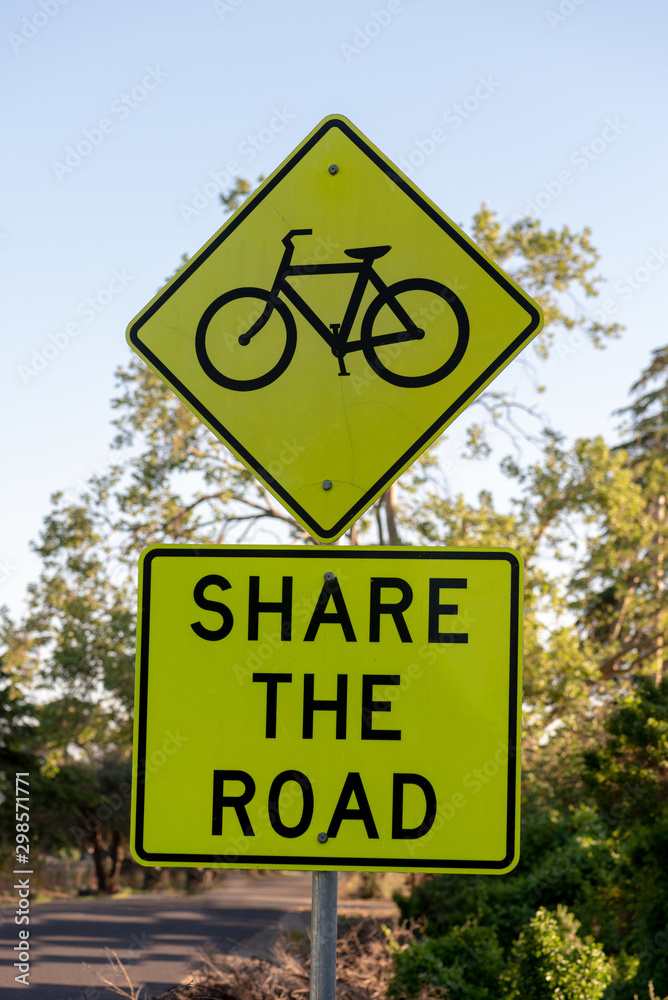 Share the road with a bike sign in a country road 