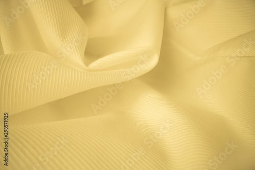 Shiny flowing cloth texture in macro shot. Wavy clean silk weave material. Textile abstract background. photo